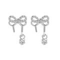 Elegant silver star bowknot earrings with cubic zirconia stones on white background - Silver Bow Single Rhinestone Drop Style / Silver