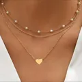 Dreilagiges goldenes Halsketten-Set mit weißen Perlen und poliertem Herzanhänger für Damen - Gold Dreilagig Herz Perle
