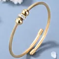 Bracciale rigido in acciaio al titanio con texture intrecciata e perline di cristallo - Oro