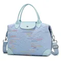 Light blue quilted travel bag with colorful embroidery and adjustable strap - Light Blue