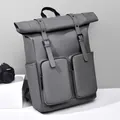 Dark grey roll-top minimalist backpack with dual front pockets and matte waterproof finish - Gray