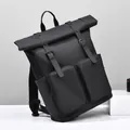 Modern black roll-top backpack with dual front zip pockets and matte waterproof finish - Black