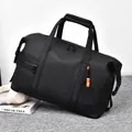 Large black matte travel duffel bag with waterproof coating and orange zipper detail - Black