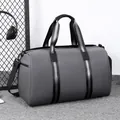 Dark grey waterproof travel bag with reinforced handles and detachable shoulder strap - Gray