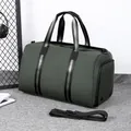Waterproof dark green travel bag with striped handles and detachable black shoulder strap - Green