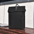 Minimalist black waterproof business backpack with front zipper pockets on wooden bench - Black