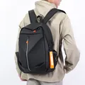 Men's black minimalist backpack with orange zipper accents and external USB charging port - Black