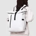 White waterproof roll-top business backpack with black straps shown on a male model - White