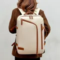 Cream white laptop backpack with brown leather accents shown on a female model - Off White
