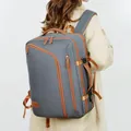 Women's stylish grey travel laptop backpack with brown leather accents shown on a model - Dark Gray