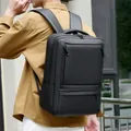 Minimalist black waterproof business backpack with large capacity worn by male model - Black