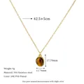 Detail view of 18K PVD gold plated oval tiger eye pendant necklace on 304 stainless steel - Brown