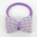 Close-up of purple plaid bow hair tie with elastic nylon band for baby girls - Purple