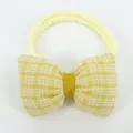 Detail of yellow checkered bow headband with high-elastic nylon band for infants - Beige