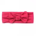 Detail of rose red baby headband featuring soft elastic fabric and a knotted bow design - Rose Red