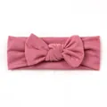 Detailed shot of soft knitted pink baby headband featuring a large tied bow - Dusty Pink