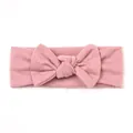 Detail of dusty pink knitted baby headband with a soft textured bow for infants - Dusky Pink
