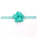 Dettaglio della fascia con fiore in tessuto verde menta con nastro elastico su cartoncino - Verde menta