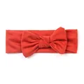 Detail of red oversized bow on soft knitted elastic baby headband with ribbed texture - Orange