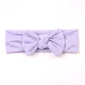 Detail of lavender ribbed knit baby headband with a large bow on a white background - Purple