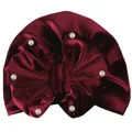 Detailed close-up of burgundy velvet baby turban hat with bow and white pearl accents - Burgundy