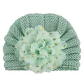 Detail of mint green baby turban knit hat featuring large floral mesh with gold dots - Mint Green
