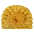 Yellow knit baby turban hat with donut top decoration on a clean white background - Yellow