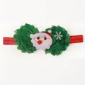 Détail du bandeau de Noël pour bébé avec fleurs en maille verte et décor peluche Père Noël - Vert