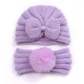 Detail of light purple baby knit hat with bow and headband with fluffy faux fur pompom - Purple