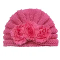 Detailed view of magenta knit baby turban hat with large layered floral decorations - Rose Red