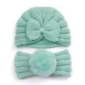 Detail of mint green baby knit set featuring bow beanie and pompom headband - Mint Green