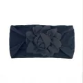 Detail of a black nylon elastic baby headband with a large handmade fabric 3D flower - Black