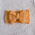 Orange infant headband with a large triple-layered knitted bow on soft ribbed fabric - Khaki/Earth Yellow