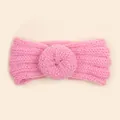Detail of soft pink knit baby headband with ribbed texture and crochet flower - Pink