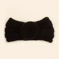 Detailed view of black knitted baby headband with ribbed texture and donut knot decoration - Black