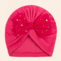 Detailed close-up of rose pink baby turban hat with a gold polka dot bow decoration - Rose Red