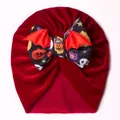 Detail of red velvet baby Halloween hat with bat wings and pumpkin bow decoration - Red