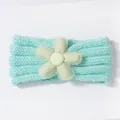 Detail of mint green knitted baby headband featuring a mesh lace fabric flower - Mint Green