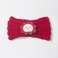 Detail of red knit baby headband featuring a cute lion patch and ribbed texture - Red
