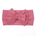 Close-up of baby mesh headband with a large handmade bow in dark pink color - Dark Bean Paste