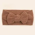 Close-up of caramel waffle texture knit baby headband with a large decorative bow - Coffee
