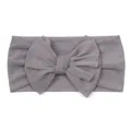 Detail of soft grey mesh baby headband featuring a large delicate layered mesh bow - Gray