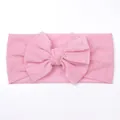 Close-up of soft pink mesh baby headband featuring a large layered mesh bow detail - Pink
