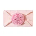 Detailed view of a soft pink baby headband featuring a fabric rose with silver stars - Light Pink