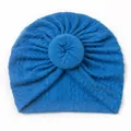 Close-up of royal blue knitted baby turban featuring a decorative donut-shaped knot - Navy Blue