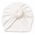 Detail of soft white baby donut hat showing textured knit fabric and decorative knot - White