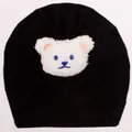 Detail of baby bear beanie showing soft cotton pleated texture and cute bear patch - Black