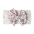 Close-up of soft baby headband with large floral bow and breathable grey fabric texture - Gray