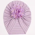 Detailed macro view of baby turban hat with purple stripes and large chiffon gold foil flower - Purple