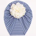 Close-up of baby striped turban hat featuring a large gold foil polka dot floral detail - Dark Blue
